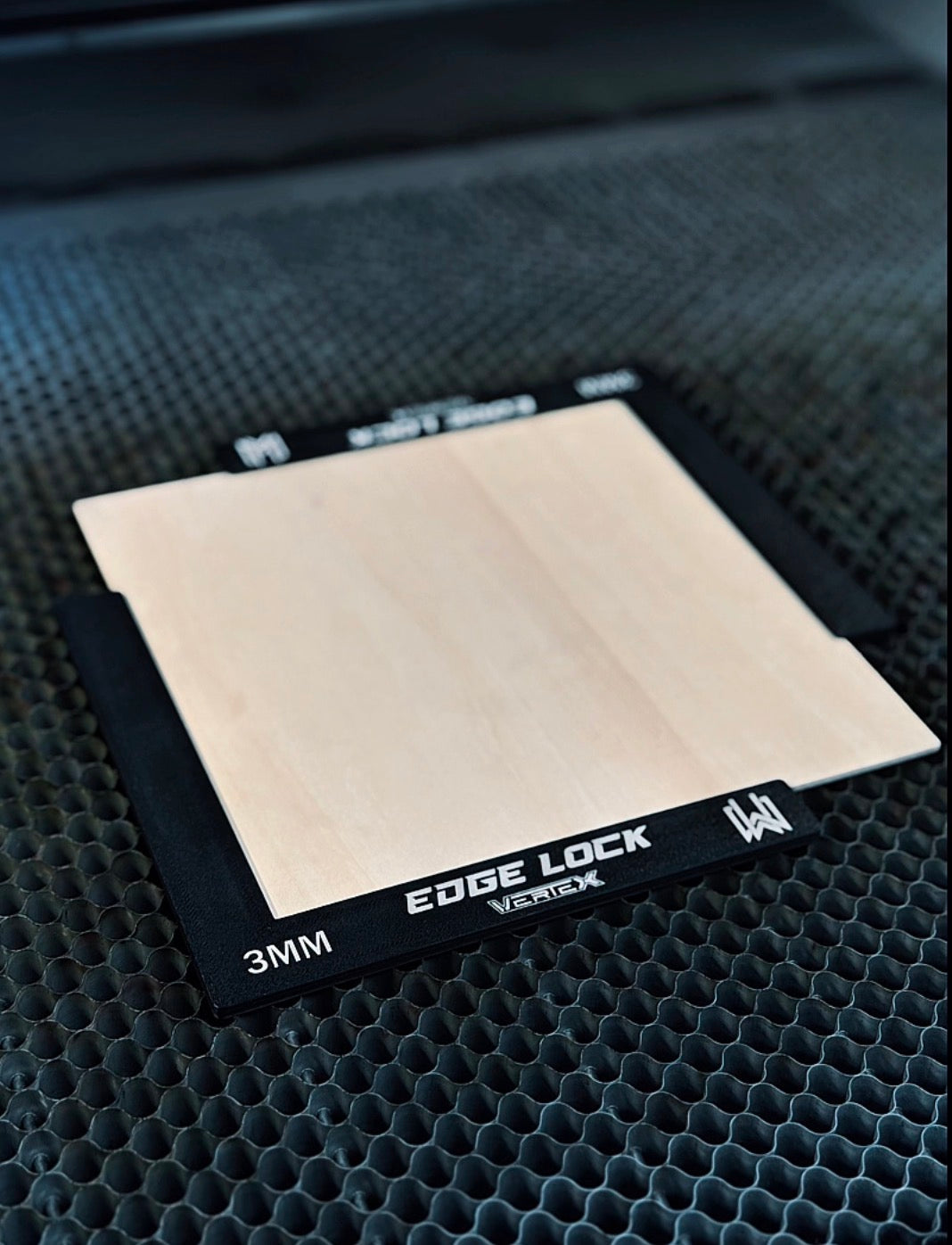 Camera lens filter with 'Edge Lock' branding on a textured black surface